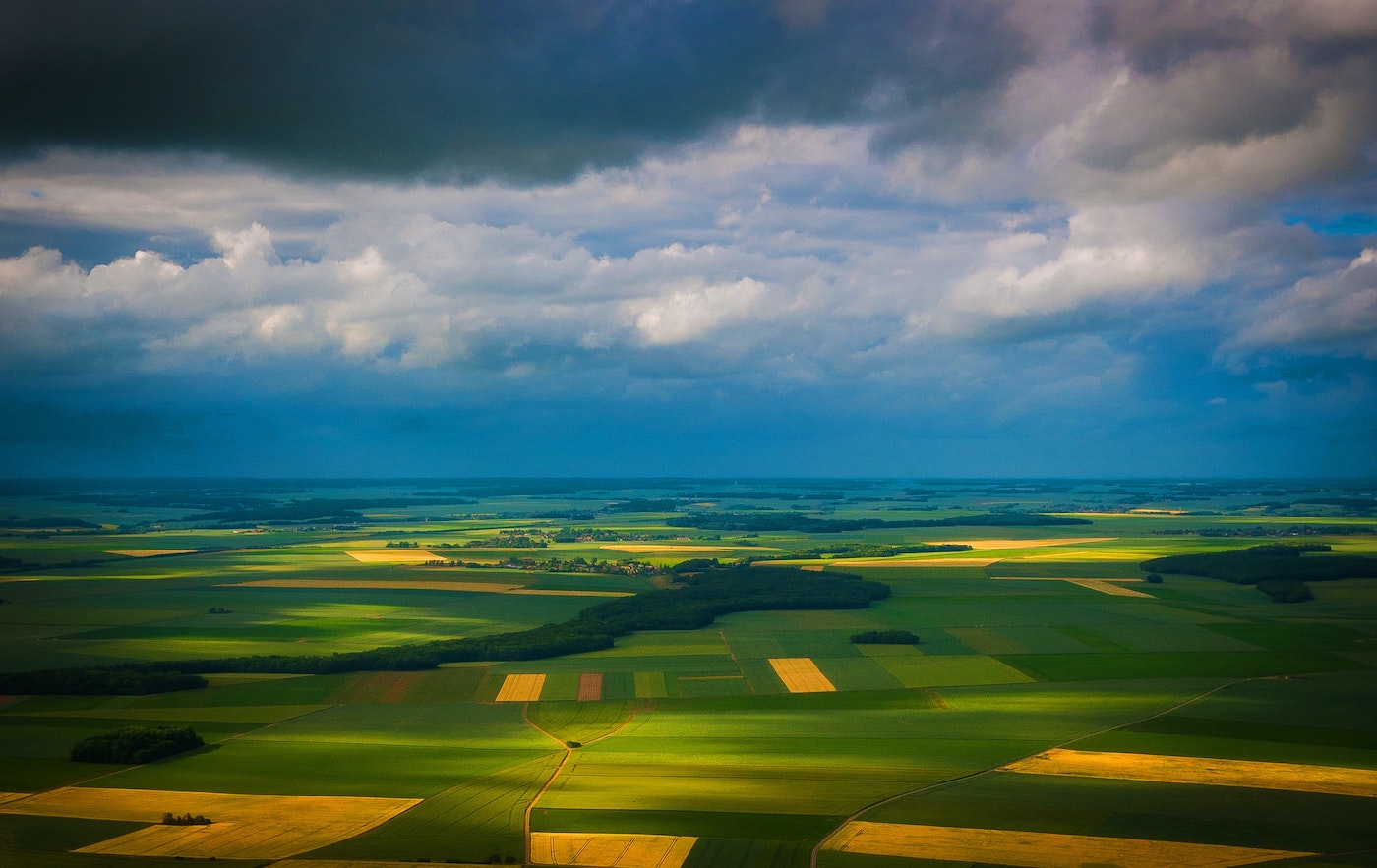 a beautiful landscape of fields seen from a plane